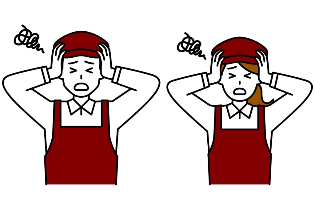 頭を抱えて悩むカフェの店員